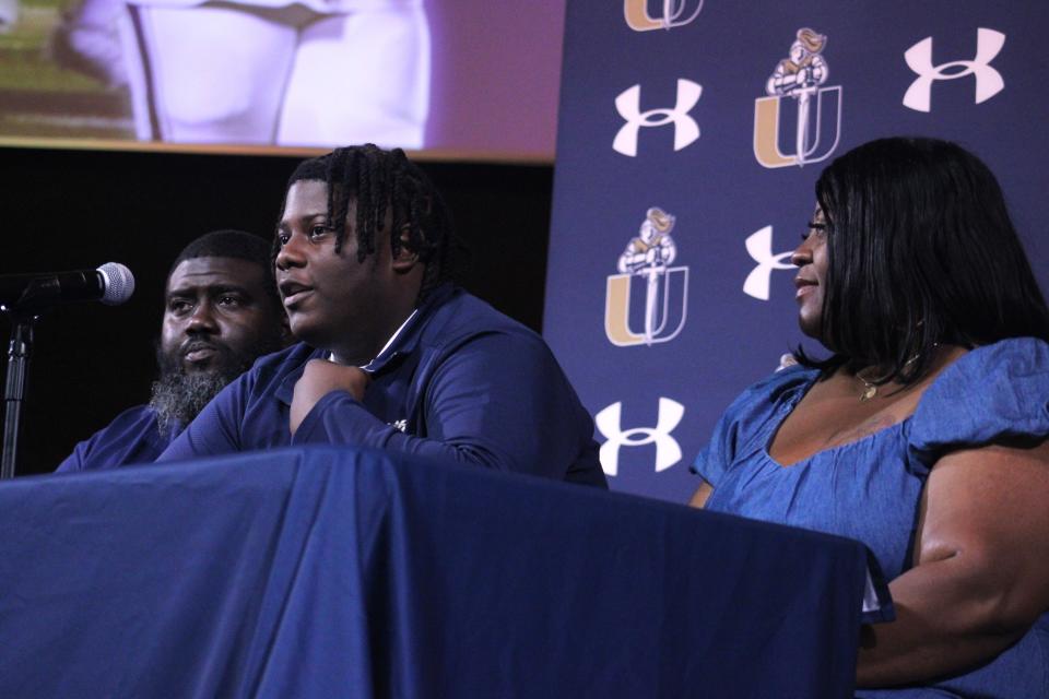 University Christian senior Andre Williams, accompanied by his family, announces his signing with Elizabeth City State University for football.