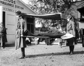 Two Red Cross nurses with a person on a stretcher during a demonstration at the Red Cross Emergency Ambulance Station during the influenza pandemic of 1918-1920, Washington DC, 1918. (Photo by Underwood Archives/Getty Images)