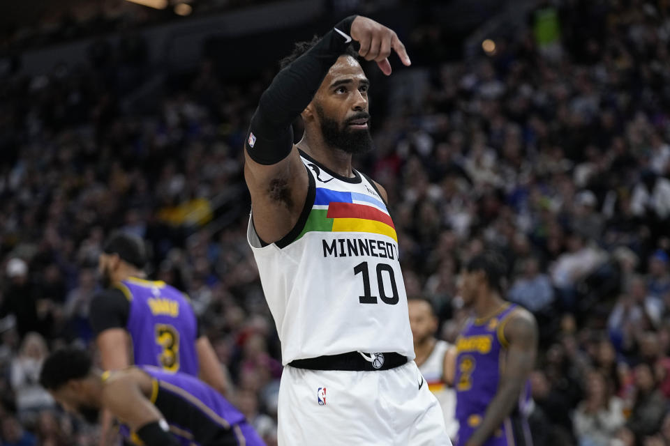 Minnesota Timberwolves guard Mike Conley celebrates after making a basket while being fouled during the first half of the team's NBA basketball game against the Los Angeles Lakers, Friday, March 31, 2023, in Minneapolis. (AP Photo/Abbie Parr)