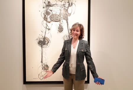 Dominique Levy, co-founder of Levy Gorvy, poses in front of "Bricolage" (1968) of Italian artist Carol Rama during the Art Basel in Basel, Switzerland, June 13, 2018. REUTERS/Moritz Hager