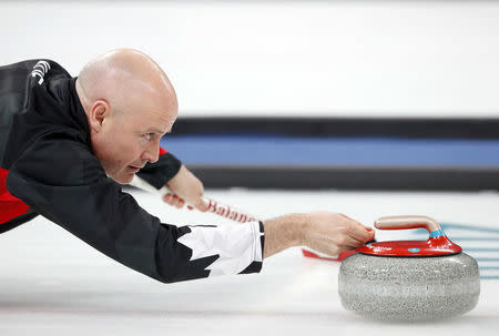 Curling - Pyeongchang 2018 Winter Olympics - Men's Semi-final - Canada v U.S. - Gangneung Curling Center - Gangneung, South Korea - February 22, 2018 - Skip Kevin Koe of Canada delivers the stone. REUTERS/Phil Noble
