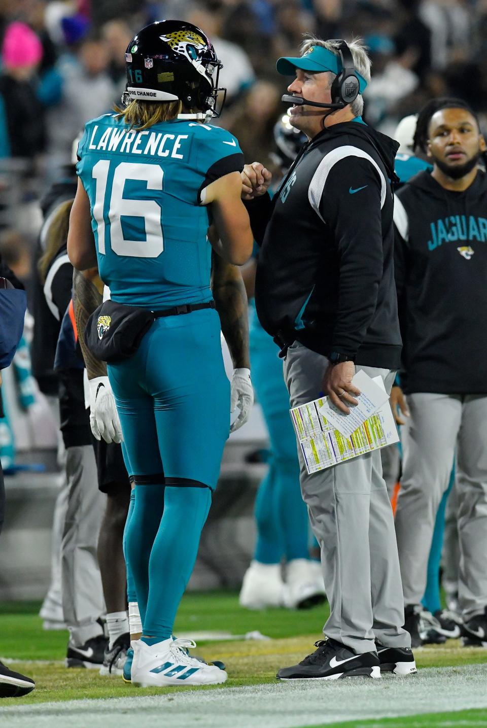 Jaguars quarterback Trevor Lawrence (16), seen here talking with Doug Pederson during last week's win over the Tennessee Titans, gives the Jacksonville franchise the best chance of sustaining success over the other two Florida NFL franchises in the playoffs.