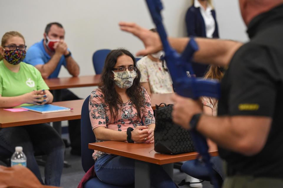 Nhel Jallouk listens to St. Lucie County Sheriff's Deputy Don Christman as he instructs a class of upcoming teachers about ways to defend themselves during an active-shooter drill Feb. 19, 2021, at the Treasure Coast Public Safety Training Complex at Indian River State College in Fort Pierce, Fla.