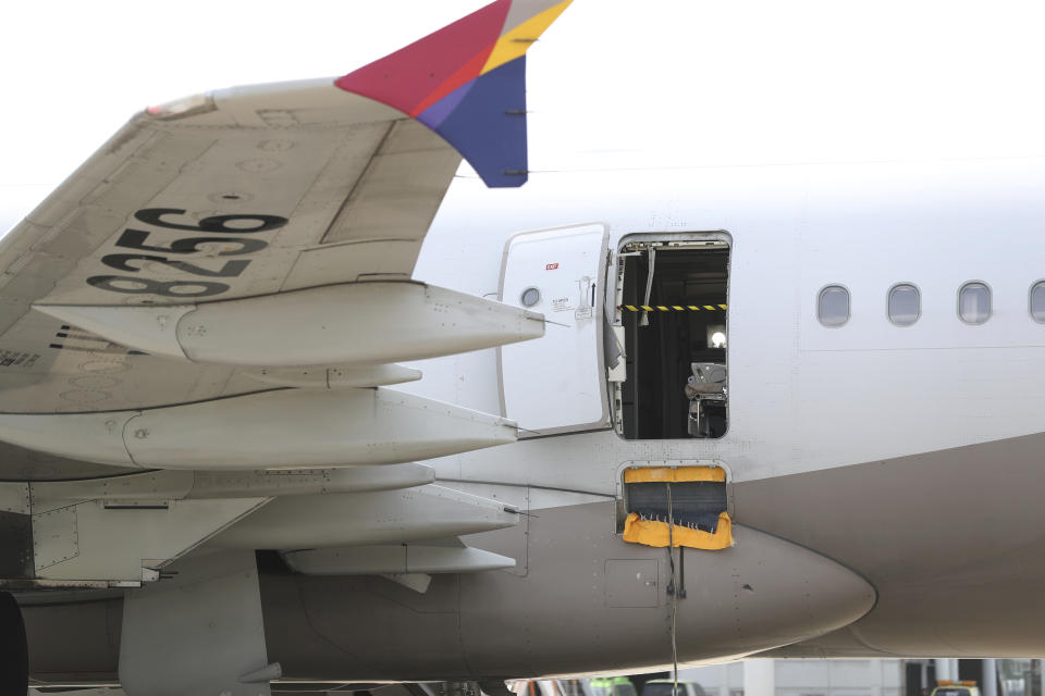 An Asiana Airlines plane is parked as one of the plane's doors suddenly opened at Daegu International Airport in Daegu, South Korea, Friday, May 26, 2023. A passenger opened a door on an Asiana Airlines flight that later landed safely at a South Korean airport Friday, airline and government officials said. (Yun Kwan-shick/Yonhap via AP)