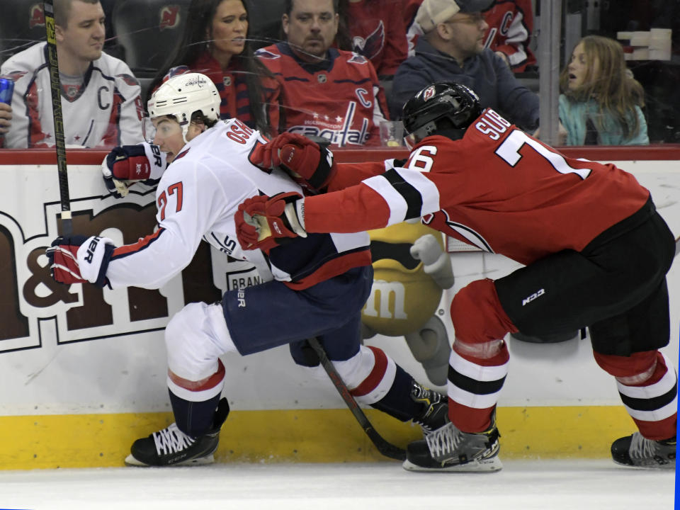 New Jersey Devils defenseman P.K. Subban (76) checks Washington Capitals right wing T.J. Oshie (77) during the first period of an NHL hockey game Saturday, Feb. 22, 2020, in Newark, N.J. (AP Photo/Bill Kostroun)