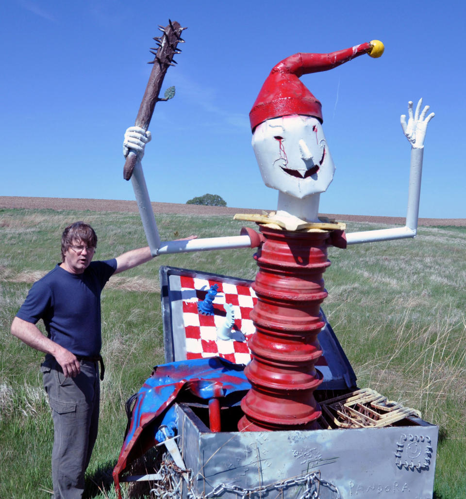 In this May 10, 2012 photo, Wayne Porter explains the concept behind a spiked mallet wielding Jack jumping out of Pandora's Box, one of the more than 40 works of art at his Porter Sculpture Park, in Montrose, S.D. (AP Photo/Dirk Lammers)