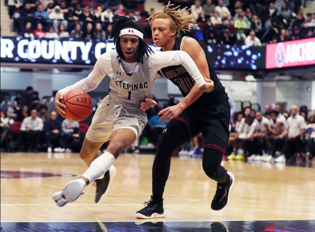 Stepinac’s Boogie Fland (1) drives around Iona’s Joe Wolf (10) during the Crusader Classic at the Westchester County Center in White Plains Jan. 6, 2024.