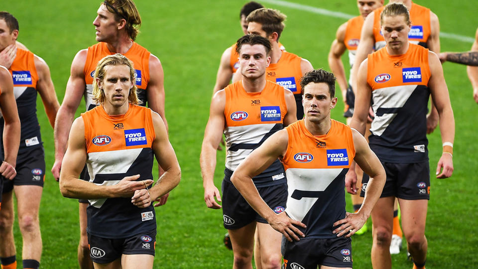 GWS Giants players, pictured here leaving the field after their loss to Sydney Swans.