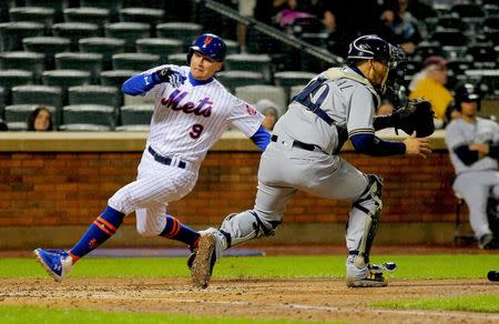 Apr 26, 2019; New York City, NY, USA; New York Mets center fielder Brandon Nimmo (9) scores on a an RBI single by third baseman Todd Frazier (not pictured) against the Milwaukee Brewers during the fourth inning at Citi Field. Mandatory Credit: Andy Marlin-USA TODAY Sports