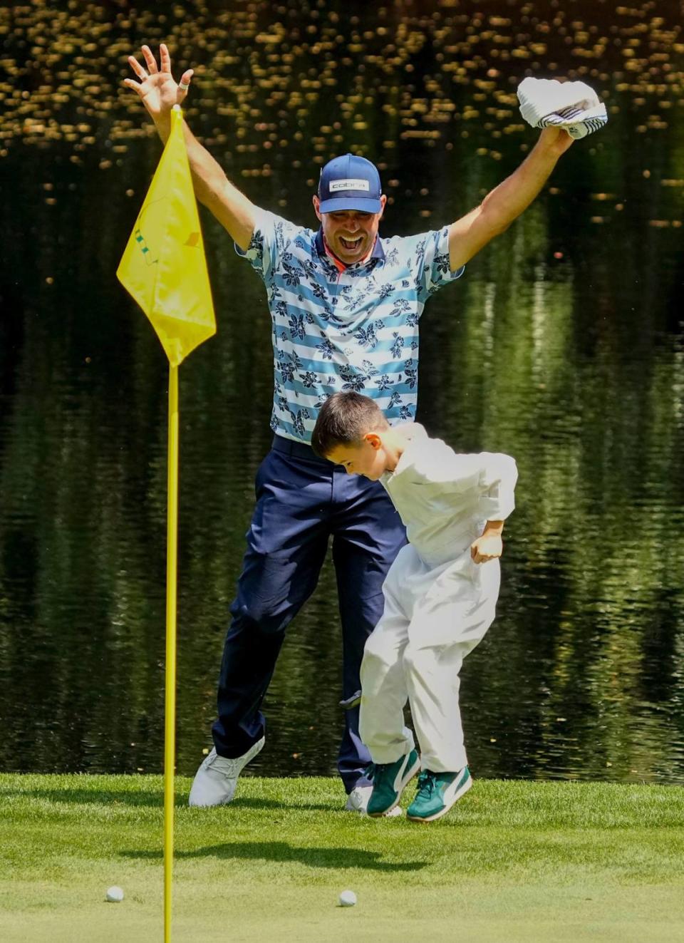 Gary Woodland celebrates a putt by his son, Jax, on the No. 9 green during the Par 3 Contest at Augusta National Golf Club in Augusta, Georgia on April 10, 2024. Adam Cairns/USA TODAY NETWORK