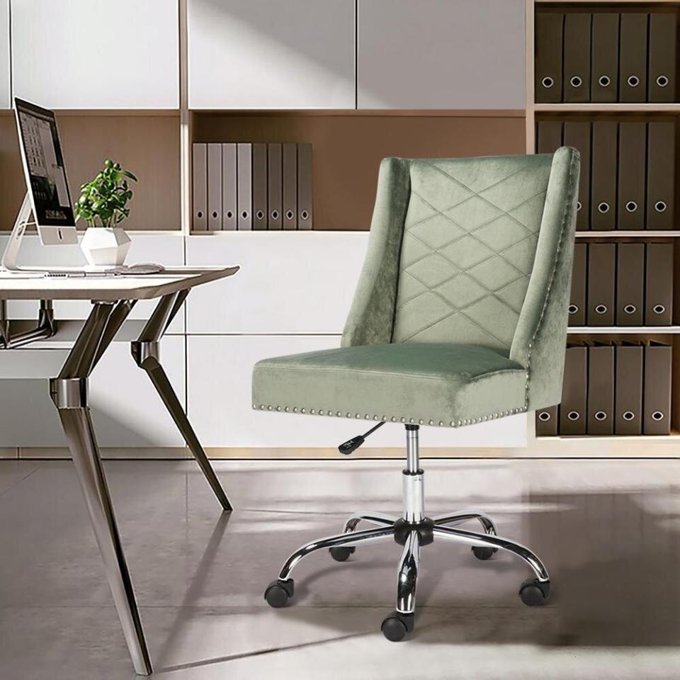 You can type away in this office chair. It has a padded backrest that'll be easy on your back and an adjustable base for whenever you're tired of being in just one position. We love the detail of the nail heads, which give the velvet a tougher edge. <a href="\" target="_blank" rel="noopener noreferrer">Originally $170, get it now for $143 at The Home Depot</a>.