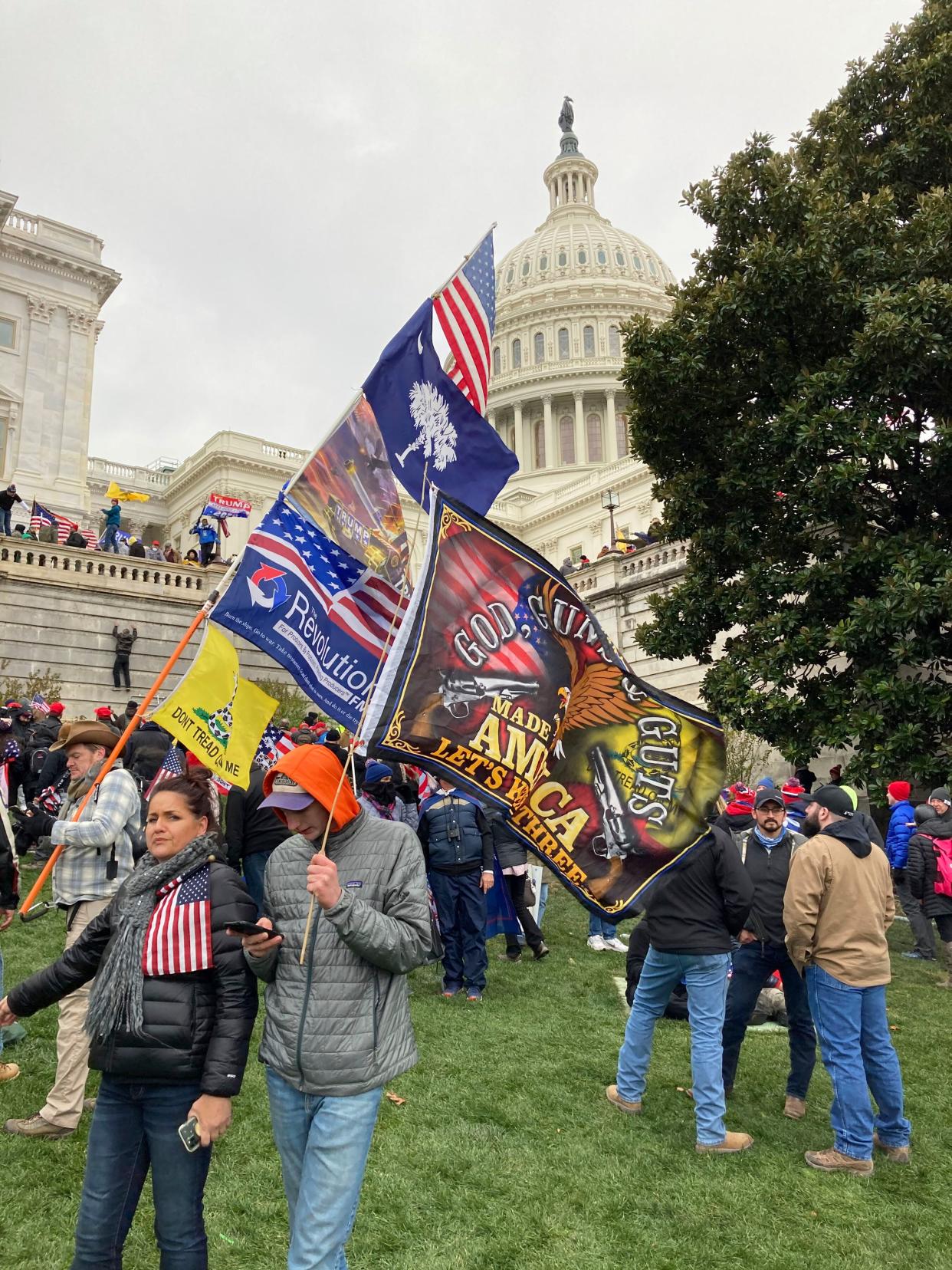 People hold flags near the U.S. Capitol, which was breached on Jan. 6 by thousands of rioters who disagreed with the results of the 2020 presidential election. (Photo: zz/STRF/STAR MAX/IPx)