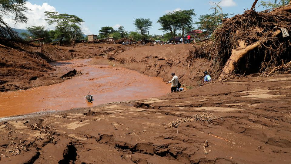 Residents gather at the river bed to search for missing people in Mai Mahiu on Monday. - Thomas Mukoya/Reuters