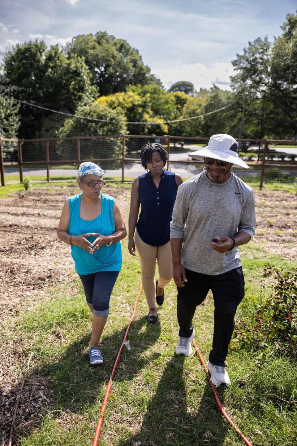 From left, Brenda Campbell, West Boulevard Neighborhood Coalition vice chair, D’Asia Feaster, neighborhood ambassador and Rickey Hall, coalition chair, in the Seeds of Change Garden in Charlotte. A grocery co-op for the community will be on the same site as the garden off Romare Bearden Drive.