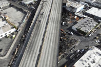 In this aerial view, Interstate 10 is empty due to a closure in the aftermath of a fire, Monday, Nov. 13, 2023, in Los Angeles. Los Angeles drivers are being tested in their first commute since a weekend fire that closed a major elevated interstate near downtown. (AP Photo/Jae C. Hong)