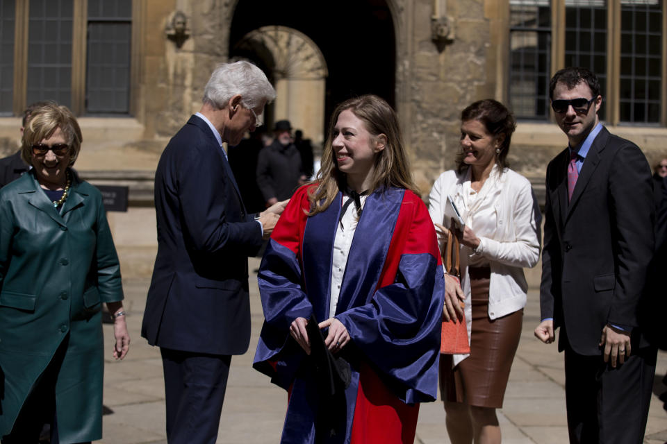 Former U.S. Secretary of State Hillary Rodham Clinton, left, her husband former U.S. President Bill Clinton, second left, their daughter Chelsea, center, and her husband Marc Mezvinsky, right, leave after they all attended Chelsea's Oxford University graduation ceremony at the Sheldonian Theatre in Oxford, England, Saturday, May 10, 2014. Chelsea Clinton received her doctorate degree in international relations on Saturday from the prestigious British university. Her father was a Rhodes scholar at Oxford from 1968 to 1970. The graduation ceremony comes as her mother is considering a potential 2016 presidential campaign. (AP Photo/Matt Dunham)