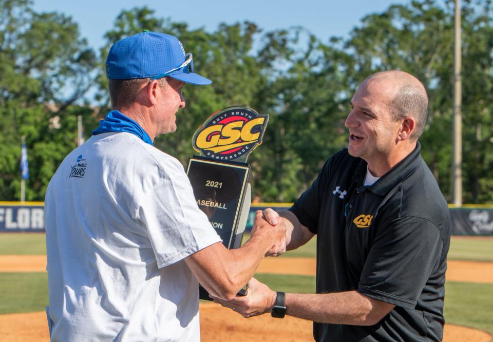 Head coach Mike Jeffcoat accepts the trophy after the UWF Argos defeat Delta State Statesmen in deciding game three of the Gulf South Conference baseball championship series at the University of West Florida in Pensacola on Thursday, May 20, 2021.  The Argos claim the GSC Championship.