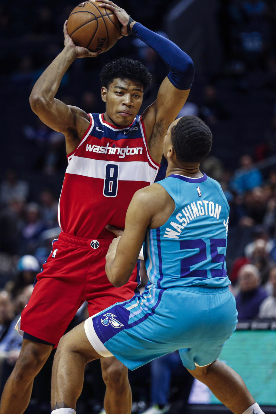 Washington Wizards forward Rui Hachimura, left, looks to drive against Charlotte Hornets forward P.J. Washington in the first half of an NBA basketball game in Charlotte, N.C., Tuesday, Dec. 10, 2019. (AP Photo/Nell Redmond)