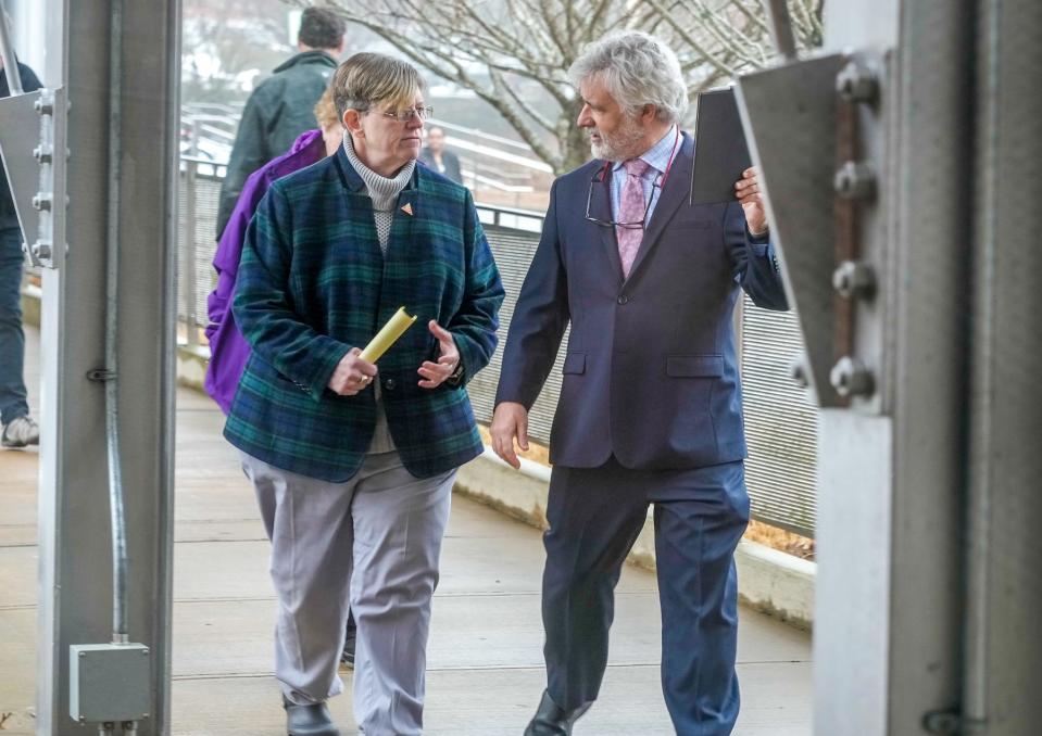 Warwick School Committee member Karen Bachus leaves District Court, Warwick, with her attorney, Jason Knight, after pleading not guilty to charges of driving under the influence and simple assault.