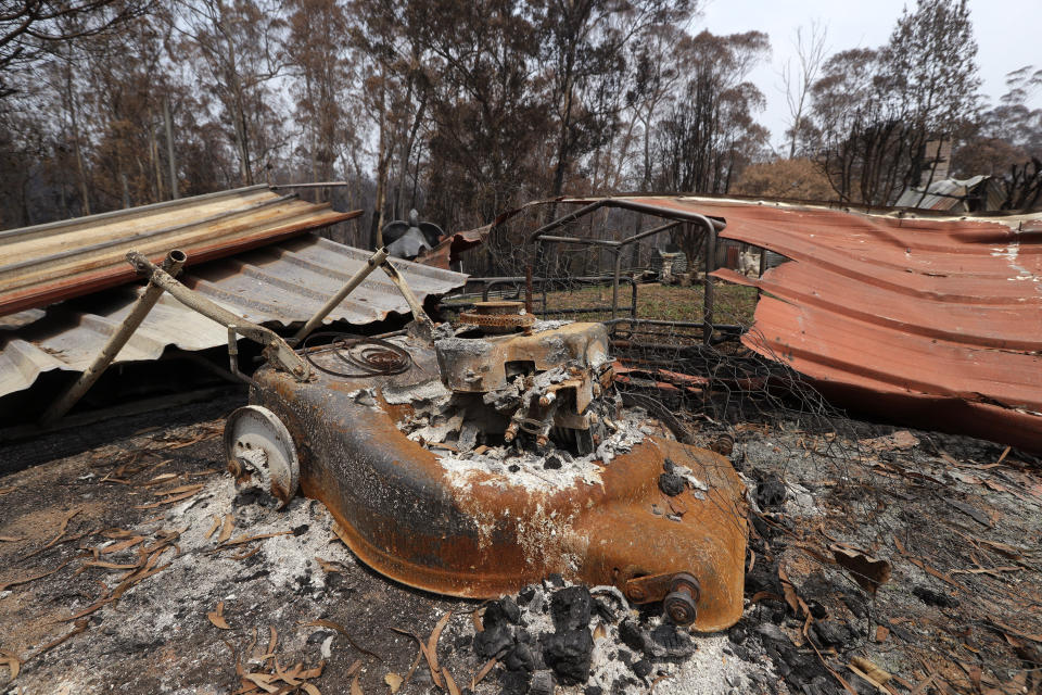A lawn mower is barely recognizable after a fire destroyed a home at Nerrigundah, Australia, Monday, Jan. 13, 2020, after a wildfire ripped through the town on New Year's Eve. The tiny village of Nerrigundah in New South Wales has been among the hardest hit by Australia's devastating wildfires, with about two thirds of the homes destroyed and a 71-year-old man killed. (AP Photo/Rick Rycroft)