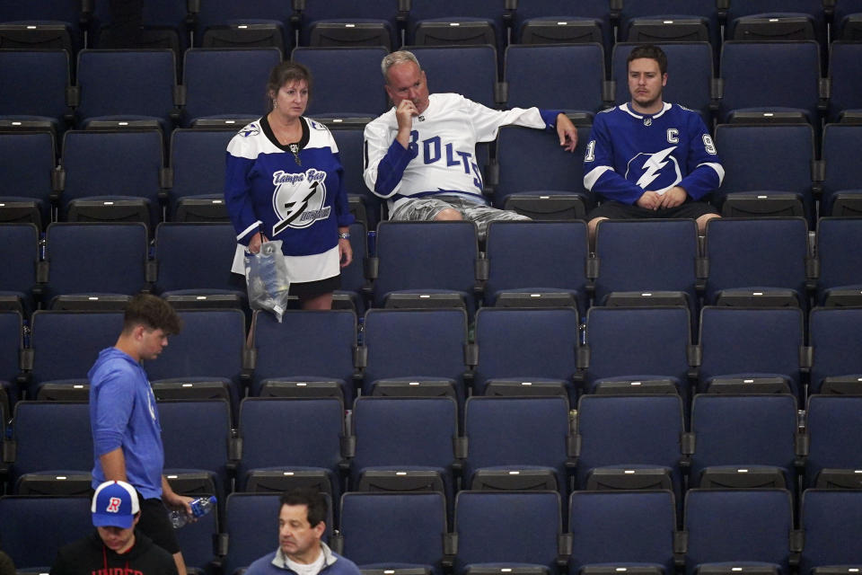 Tampa Bay Lightning fans watch as the Colorado Avalanche celebrate their championship of the NHL hockey Stanley Cup Finals on Sunday, June 26, 2022, in Tampa, Fla. (AP Photo/John Bazemore)