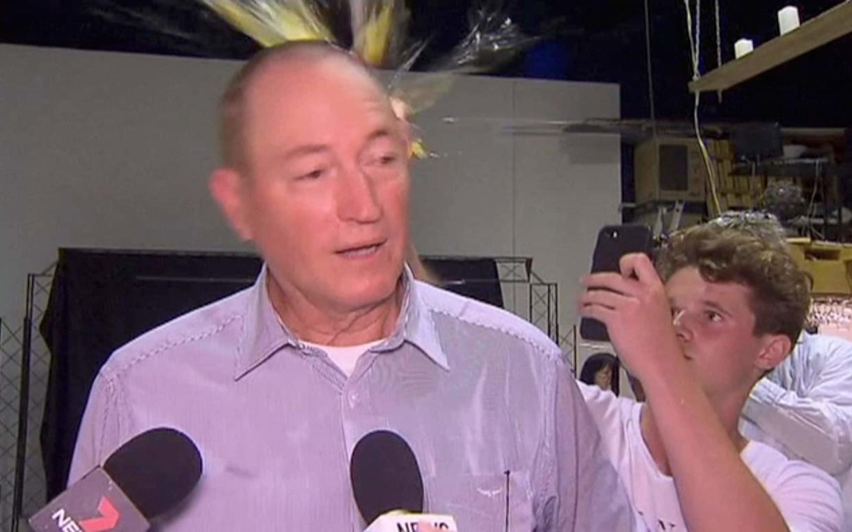 Will Connolly breaks an egg on the head of Senator Fraser Anning while he holds a press conference - AP