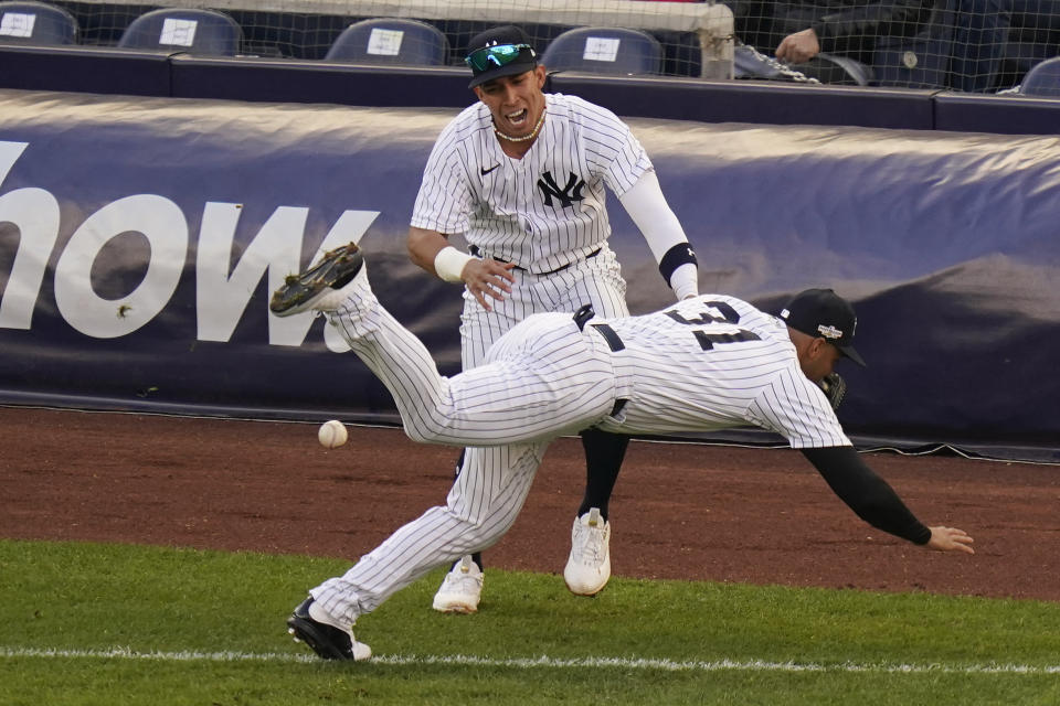 New York Yankees Oswaldo Cabrera collides with Aaron Hicks (31) while chasing a pop fly by Cleveland Guardians Steven Kwan during the third inning of Game 5 of an American League Division baseball series, Tuesday, Oct. 18, 2022, in New York. (AP Photo/Seth Wenig)