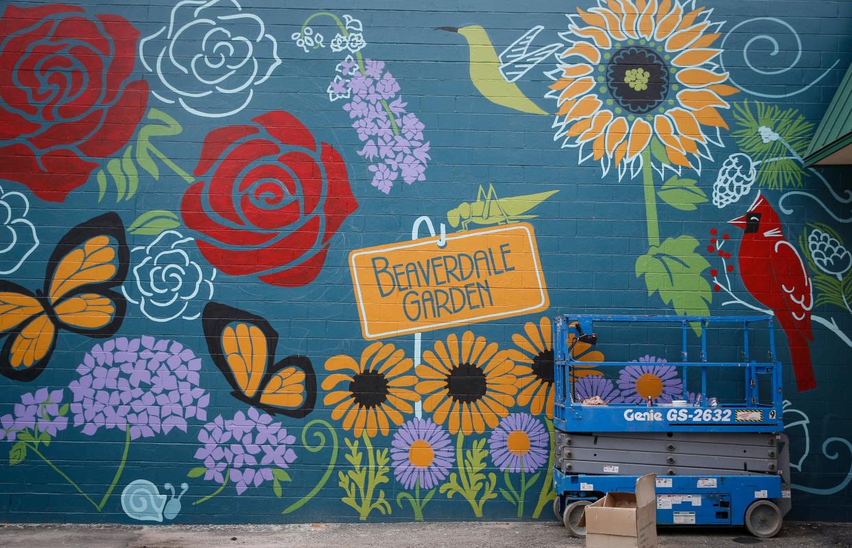 Artists Geri Boesen and Joshua Spain created this mural on the wall behind Custom Upholstery.