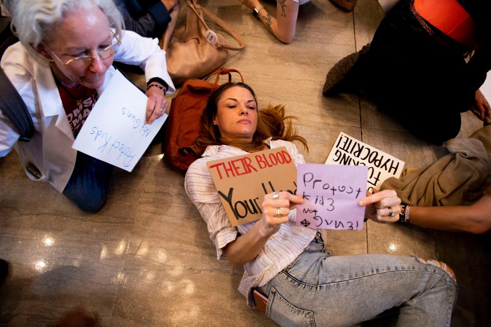 Protesters hold a “die-in” in the rotunda after the House voted to adopt SB 1325 during session at the Tennessee Capitol in Nashville, Tenn., Tuesday, April 23, 2024.