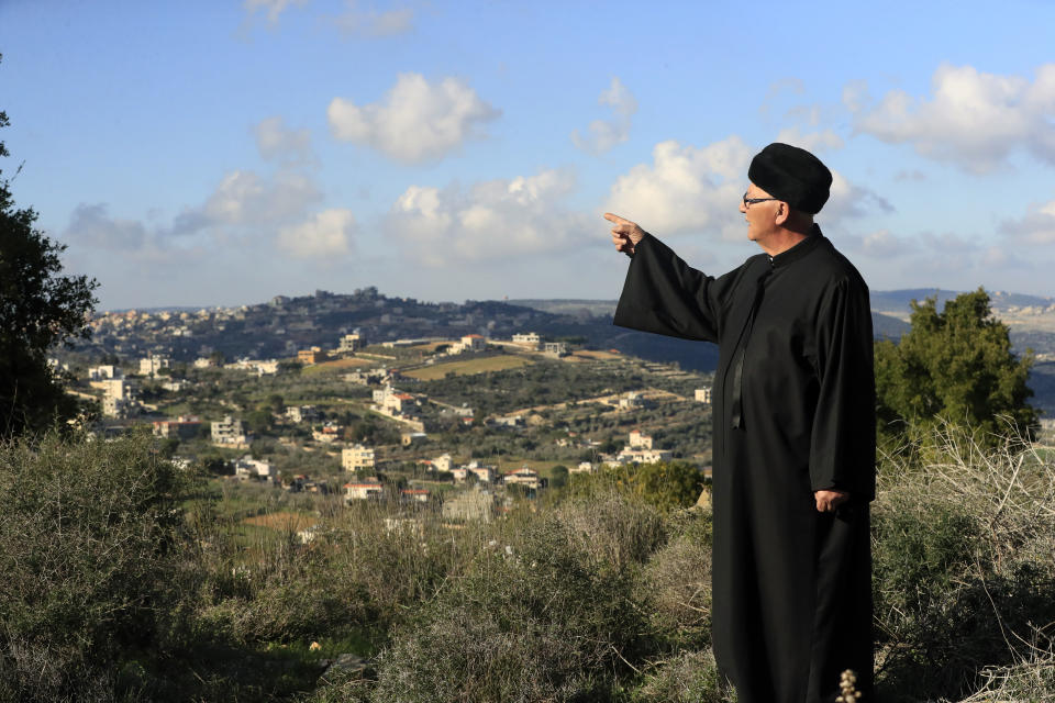 Najib al-Ameel stands on a hill overlooking his hometown Rmaych along the Lebanese-Israeli border, Lebanon, Wednesday, Jan. 18, 2023. Green Without Borders that is active in southern Lebanon, including areas along the border with Israel, is being blamed by Israel, the U.S. and some in Lebanon for being an arm for Hezbollah to cover some of the group's military activities. The association denies such charges. (AP Photo/Mohammed Zaatari)