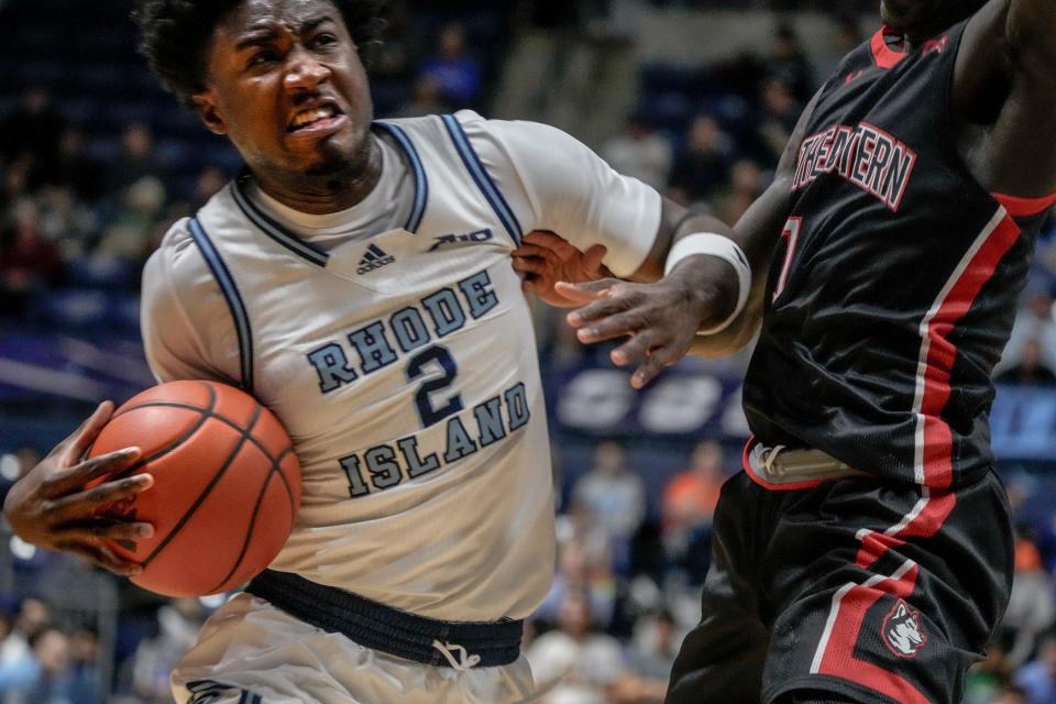 Rhode Island's Jaden House goes to the hoop against a Northeastern defender on Saturday at the Ryan Center. House finished with 19 points in the win.