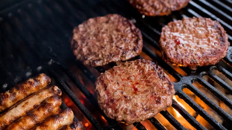 Burgers and sausages on grill