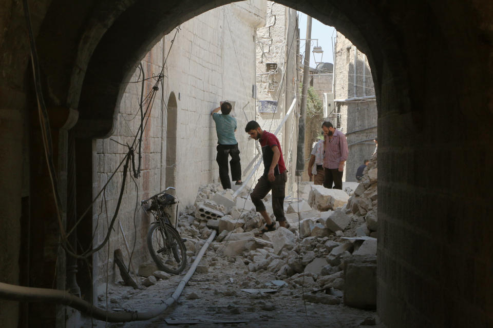 Residents inspect their damaged homes after an airstrike on the rebel-held Old Aleppo, Syria on Aug. 15, 2016.