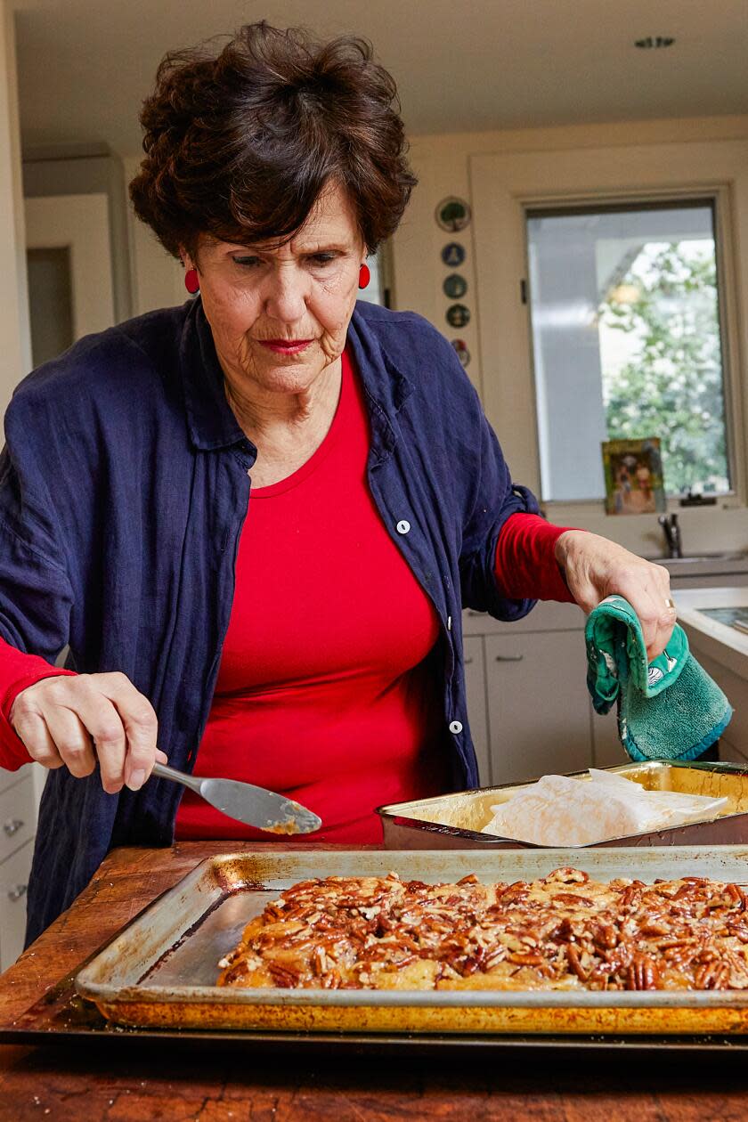 WASHINGTON, DC - Joan Nathan turns over her Ann Arbor schnecken (hot pecan rolls) after they've baked April 3, 2024. 