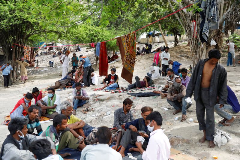 Daily wage workers and homeless people are seen on the banks of Yamuna river near a government-run night shelter during a 21-day nationwide lockdown to limit the spreading of coronavirus disease (COVID-19), in the old quarters of Delhi