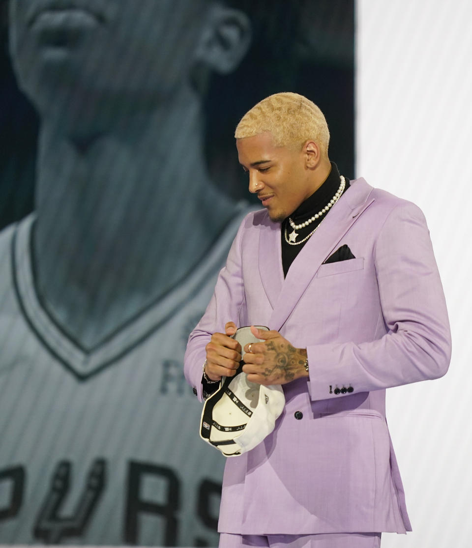 Jeremy Sochan walks across the stage after being selected ninth overall by the San Antonio Spurs in the NBA basketball draft, Thursday, June 23, 2022, in New York. (AP Photo/John Minchillo)