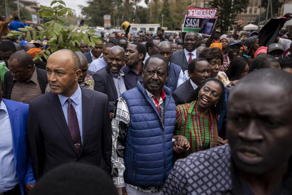 Presidential candidate Raila Odinga, center, accompanied by running mate Martha Karua, center-right, arrive to hand over the petition to the Supreme Court challenging the election results, in Nairobi, Kenya Monday, Aug. 22, 2022. Odinga filed a Supreme Court challenge to last week's election result, asserting that the process was marked by criminal subversion and seeking that the outcome be nullified and a new vote be ordered. (AP Photo/Ben Curtis)