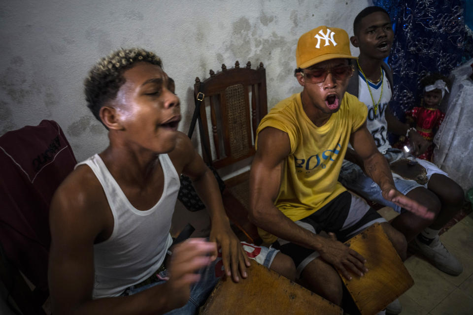 Drummers perform during a Santería ceremony in Mandy Arrazcaeta's home, in Havana, Cuba, Sunday, Nov. 13, 2022. Santería was born as a form of quiet resistance among the island's black communities. The religion dates back centuries to when Spanish colonists brought in hundreds of thousands of African slaves. (AP Photo/Ramon Espinosa)