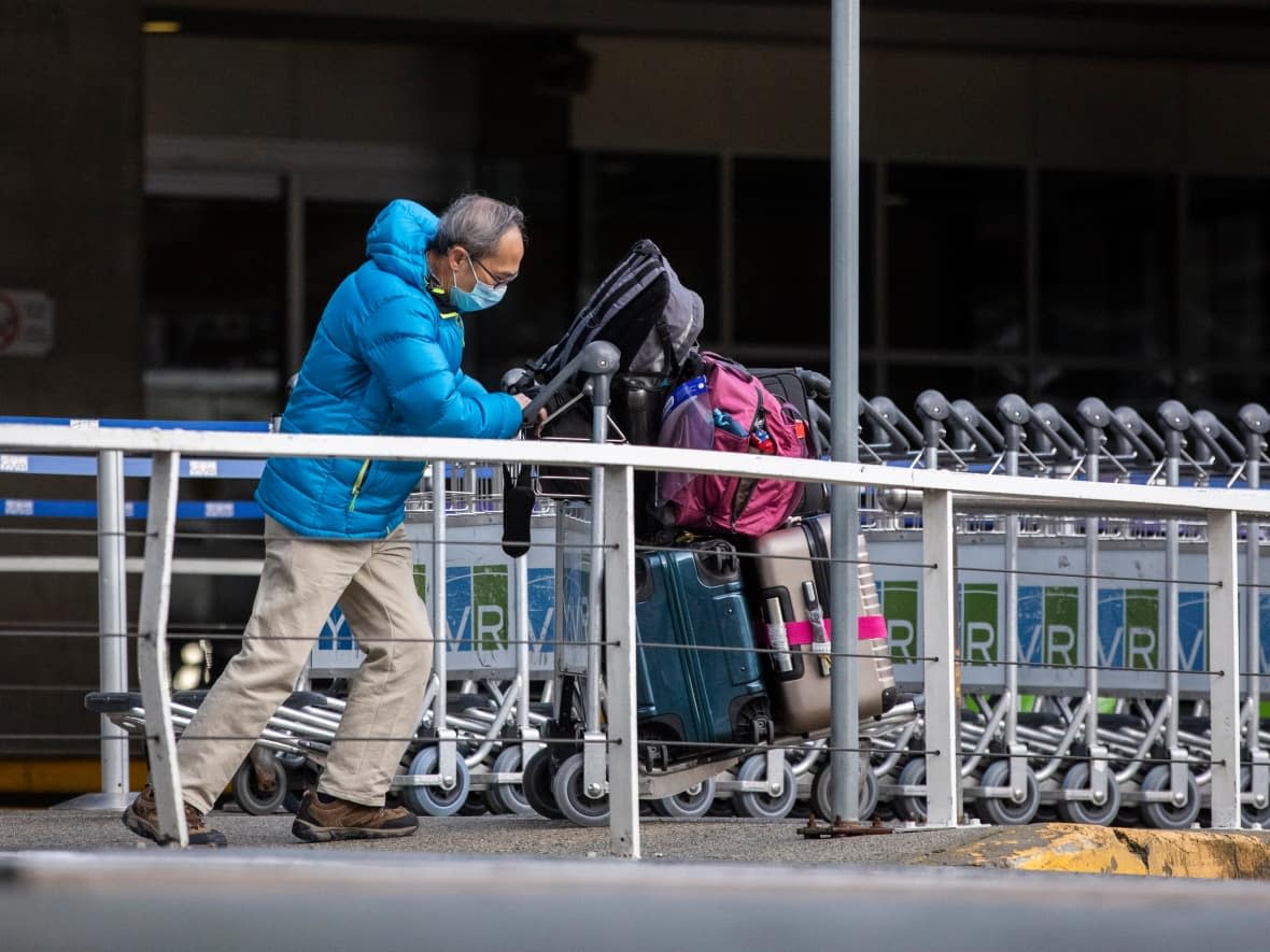 Travellers are pictured outside International arrivals at YVR International Airport in Richmond, British Columbia on Thursday, December 31, 2020. (Ben Nelms/CBC - image credit)