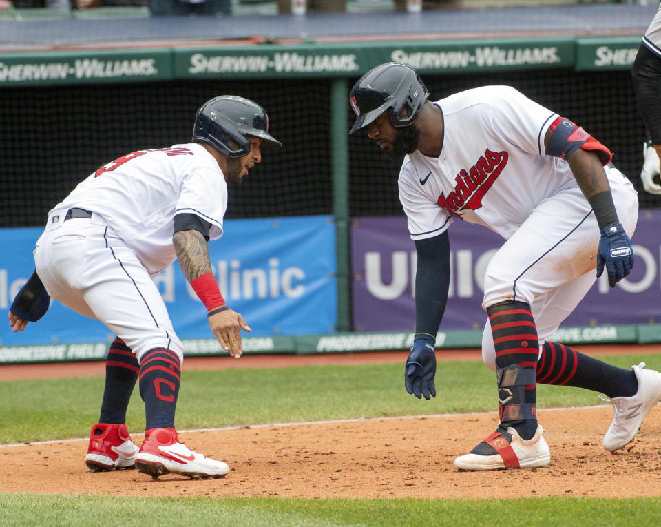 Cleveland Indians' Eddie Rosario, left, congratulates Franmil Reyes who hit a three-run home run off New York Yankees starting pitcher Jameson Taillon during the fourth inning of a baseball game in Cleveland, Sunday, April 25, 2021. (AP Photo/Phil Long)