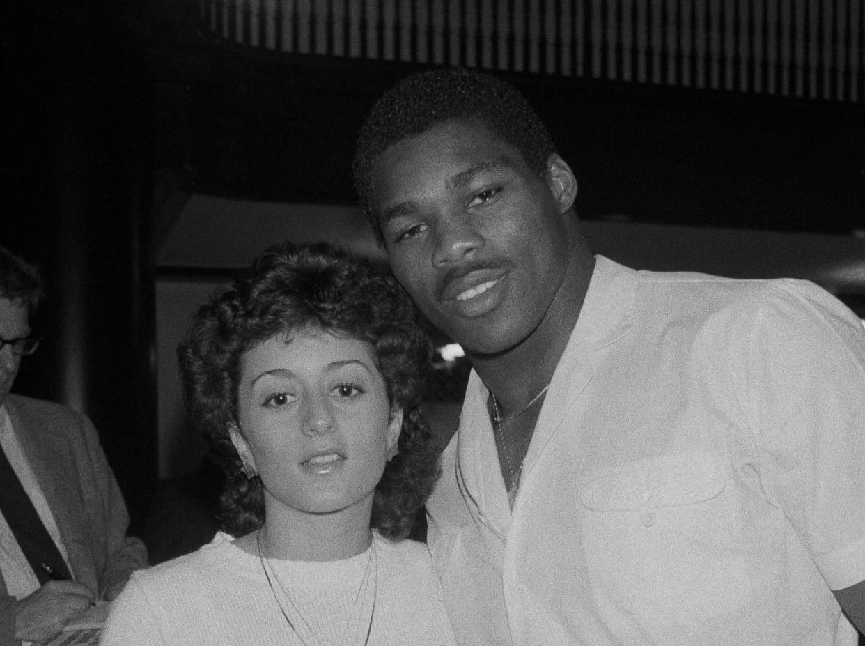 Herschel Walker and his wife, Cindy, pose for photographers during a press conference in New York, April 6, 1983, where it was announced that Walker signed a long-term agreement to endorse sports articles for a manufacturer. 