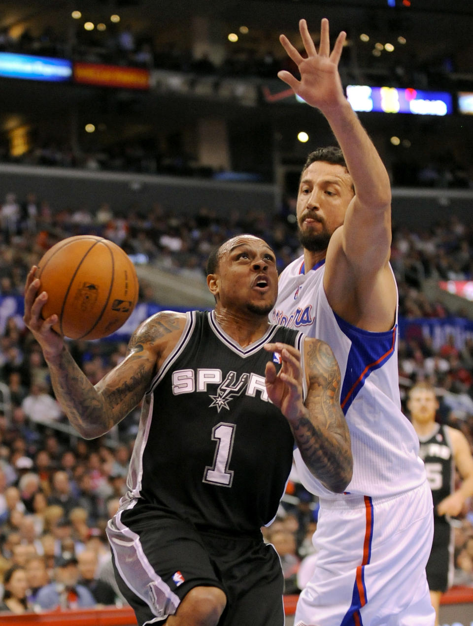 San Antonio Spurs guard Shannon Brown (1) gets by Los Angeles Clippers forward Hedo Turkoglu (8), of Turkey, as he drives to the basket for a basket in the first half of a NBA basketball game, Tuesday, Feb. 18, 2014, in Los Angeles.(AP Photo/Gus Ruelas)