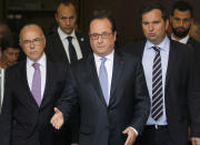 <p>French President Francois Hollande ©, Interior Minister Bernard Cazeneuve (L) and French Interior Ministry spokesman Pierre-Henry Brandet ® leave the city hall after two assailants had taken five people hostage in the church at Saint-Etienne-du -Rouvray near Rouen in Normandy, France, July 26, 2016. (REUTERS/Pascal Rossignol)</p>