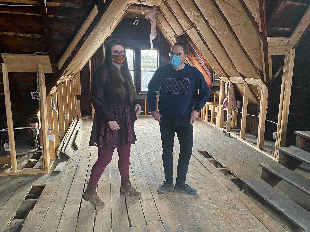 Kate and Cameron Reinhart stand in their 1880's Octagon house they are renovating during the coronavirus pandemic, in Norwich, eastern Connecticut, U.S., January 14, 2021. Picture taken January 14, 2021. REUTERS/Dan Fastenberg