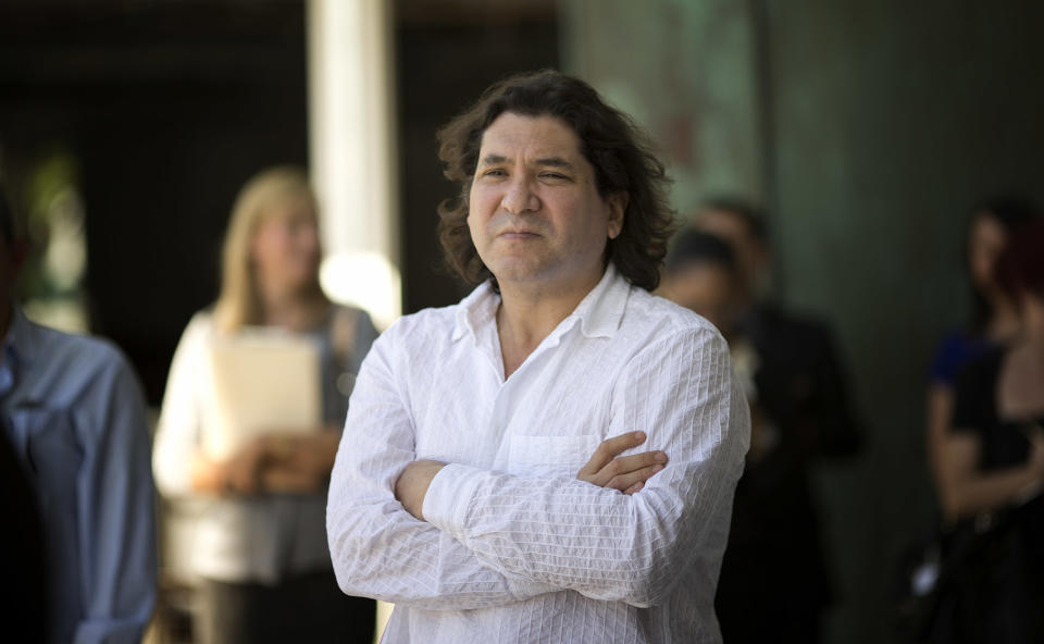 Chef Gaston Acurio watches as people invited to the launch of his cafe, LeMar, Wednesday, Dec. 18, 2013 in Miami, eat his food. He has been called the unofficial ambassador of Peruvian cuisine, but chef Acurio prefers to share that title with his fellow countrymen. With some 40 restaurants across the world, from Madrid to Miami, Acurio is undoubtedly the face of Peruvian cuisine. His flagship restaurant, Astrid&Gaston, was ranked 14 on this year’s World’s 50 Best Restaurants and his latest spot, La Mar at the Mandarin Oriental in Miami, is scheduled to launch in February. (AP Photo/J Pat Carter)