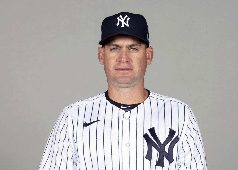 In this Feb. 24, 2021, photo, Carlos Mendoza of the New York Yankees poses for a photo in Florida. Yankees manager Aaron Boone took a leave of absence from the team to get a pacemaker and intends to return to work in a few days. Bench coach Mendoza took over as acting manager for Wednesday night's exhibition against Toronto in Tampa, Fla. The 41-year-old was a minor leaguer mostly with San Francisco and the Yankees from 1997-09 and is starting his 13th season working for the Yankees. (Mike Carlson/MLB Photos via AP, File)