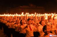 People take part in a procession to commemorate the 75th anniversary of the founding of the ruling Workers' Party of Korea (WPK), in Pyongyang