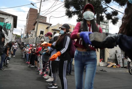 People clean debris from the streets in the aftermath of the last days' protests in Quito