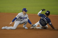 Tampa Bay Rays' Randy Arozarena gets tagged out stealing by Los Angeles Dodgers second baseman Enrique Hernandez during the first inning in Game 4 of the baseball World Series Saturday, Oct. 24, 2020, in Arlington, Texas. (AP Photo/Eric Gay)