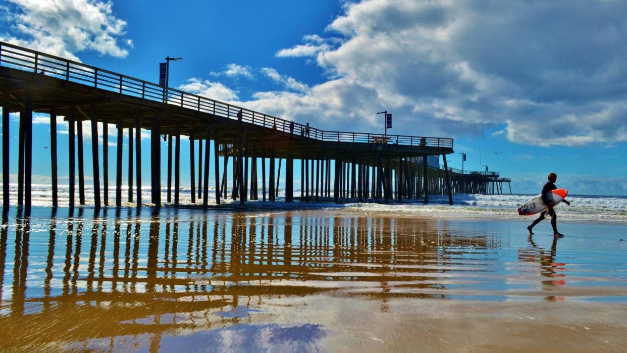 Surfer at Pismo Pier in San Luis Obispo.